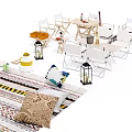 Outdoor Table And Chair Set With Decorative Pillows Lanterns And Patterned Rug