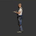 Male Worker In Denim Overalls With Knee Pads Standing And Gesturing On Gray Background