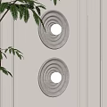 Textured Round Wall Sconces With Soft Light On White Paneled Wall And Green Fern