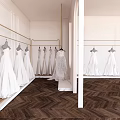 Elegant Bridal Shop Interior With White Wedding Dresses On Gold Hangers And Herringbone Wooden Floor
