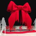 Giant Red Bow Installation With Silhouette People Red More Text Surrounded By Red Flowers