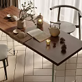 Wooden Tea Table with Glass Legs Gray Chairs Tea Set Open Book and Potted Plant