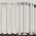 White Columns of Various Styles With Carved Capitals Arranged Against a Wall