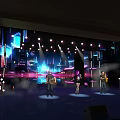 Vibrant Stage Performance With Colorful Lighting Live Music And Background Screen