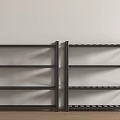Black Metal Display Shelves with Multiple Layers Against Light Colored Wall and Wooden Floor