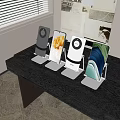 Different Color Phone Stands Holding Mobile Phones On Black Desktop Setup