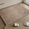 Beige Woven Square Rug On Wooden Floor With Books And Television Display Area