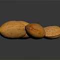 Five Fresh Orange Speckled Almonds Placed on Black Reflective Surface
