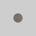 Gray Textured Sphere Component Placed On Light Colored Surface Against Textured Gray Wall