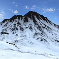 Scenic Snowy Mountain Peak Landscape With Blue Sky And White Clouds