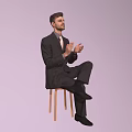 Man in Black Suit With Tie Sitting on Chair Clapping Hands Against Light Purple Background