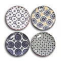 Four Decorative Plates Featuring Intricate Colorful Geometric Circular and Dotted Patterns