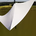 Garden Landscape With White Shade Sail Green Grass Trees And Distant Hills