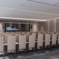 Modern Large Conference Room With Multiple Rows Of Gray Seats Lighting And Wall Design