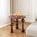 Dark Brown Wooden Side Table with Three Spherical Legs and Fruit Bowl Holding Fresh Fruits