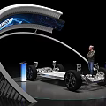 Car Chassis Display on Exhibition Stand with Person Observing and Blue Screen Background