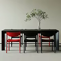Modern Dining Table Set with Black Table Red and Black Chairs and Green Plant Vase