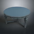 Round Dining Table With Ornate Carvings On Legs And Smooth Tabletop