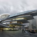 Modern Office Building With Streamlined Roof Glass Curtain Walls And Pedestrians