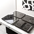 Modern Black Electric Cooktops On Marble Countertop In Kitchen Interior