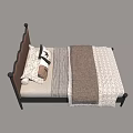 Single Bed Featuring Brown Leather Scalloped Headboard Black Metal Frame Pillows and Patterned Quilt