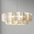 Modern White Chandelier With Wavy Petal Design Hanging In Gray Room With Soft Light