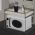 White Microwave Oven On Glass Shelf With Mug And Pen Holder In Kitchen
