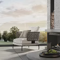 Single Sofa Outdoor Patio Woven Design with Cushions Near Fireplace Green Trees and Sky View