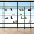Modern Glass Bookshelf with Books and Decorative Items by Large Windows in Bright Room
