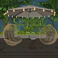 Outdoor Rattan Hanging Chairs with Cushions Under Umbrella String Lights and Wooden Deck