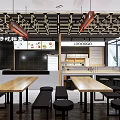 Modern Restaurant Interior With Wooden Long Tables Black Stools And Grid Ceiling
