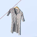 Light Colored Patterned Short Sleeve Shirt Dress Hanging on Wooden Hanger
