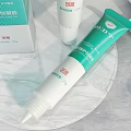Perfume Cosmetics Skincare Creams And Serums With Green White Packaging On Marble Stand