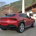 Red Sports Car Parked Outdoor With Mountain View Building And Flag