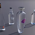 Collection of Transparent Liquor Bottles with Various Labels on Gray Background