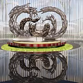 Sleek Metallic Wave Sculpture on Red Pedestal with Green Lawn Floor Reflection