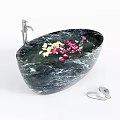 Black Marble Oval Bathtub With Yellow Pink Flower Petals Silver Faucet And Slippers
