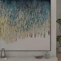 Abstract Landscape Painting with Blue Gold Dripping Texture on White Interior Wall and Green Plant