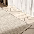 Square Beige Woven Rug On Wooden Floor With Curtains And Natural Light