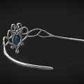 Elegant Silver Jewelry With Intricate Curly Metal Design Central Blue Gemstone And Small Blue Stones