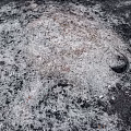 Burnt Garden Ornament Area With Black Ash White Residues Small Stones And Debris