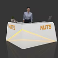 Exhibition Reception Desk Featuring White Surface Orange NUTS Logo Yellow LED Strips And Laptop
