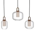 Three Modern Ribbed Glass Pendant Lights With Golden Metal Frames And Warm Glow