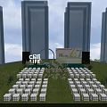 Outdoor Event Stage On Green Lawn With Neatly Arranged White Seats And High Rise Buildings