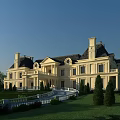 Luxury European Style Detached Villa With Yellow Exterior Dark Roof And Lawn Greenery