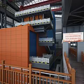 Industrial Building Interior With Multi Level Platforms Orange Blue Walls White Railings Safety Signs