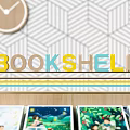 Stylish Modern Bookshelf Design With Displayed Books Sofa Pillows Geometric Wallpaper Clock And Lamp