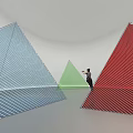 Colorful Geometric Art Installation With Blue Green Red Triangles And Human Figure In White Space