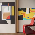 Abstract Paintings With Geometric Shapes And Vibrant Colors On Wall With Red Chair
