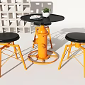 Black Round Table And Chairs With Orange Base Black Seats Magazine And Small Potted Plant